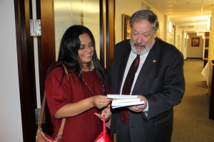 Abigail McCallister-Guerrero shows her book of poetry to the Ambassador of El Salvador to the Organization of American States